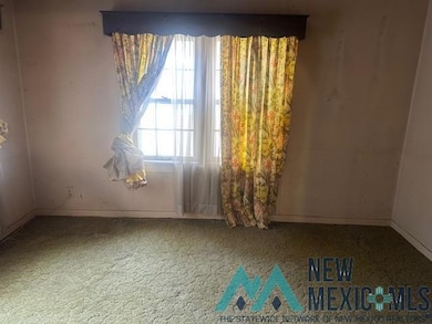 Unfurnished room featuring carpet floors and baseboards