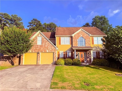 View of front of property featuring driveway and brick siding