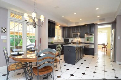 The custom kitchen includes a breakfast area with 