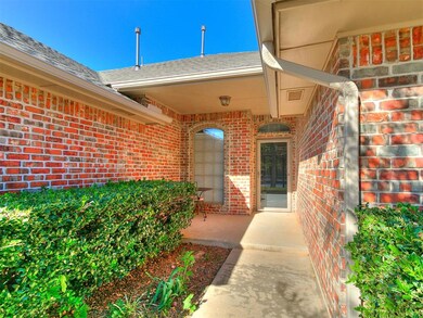 Property entrance with brick siding and a shingled roof