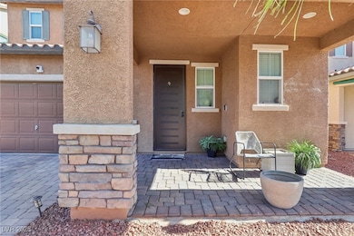 Entrance to property with stucco siding and a gara