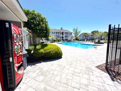 Community pool with fence, a patio, and a residential view