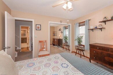 Carpeted bedroom featuring ceiling fan