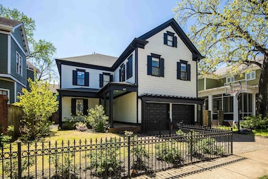 View of front of property with a garage, a fenced front yard, concrete driveway, and a shingled roof