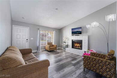 Living area featuring baseboards, lofted ceiling,