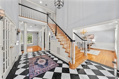 Entrance foyer featuring ornamental molding, decor