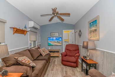 Living room with wood walls, lofted ceiling, ceili