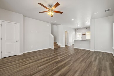 Unfurnished living room featuring a ceiling fan, 