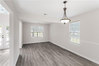 Unfurnished room featuring wood finished floors and french doors