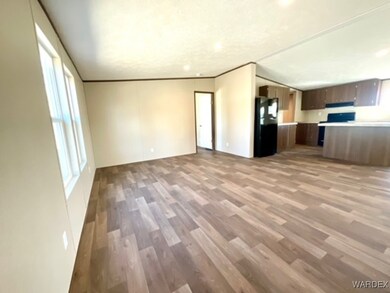 Unfurnished living room with ornamental molding an