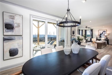 Dining space featuring light wood-style floors, ce