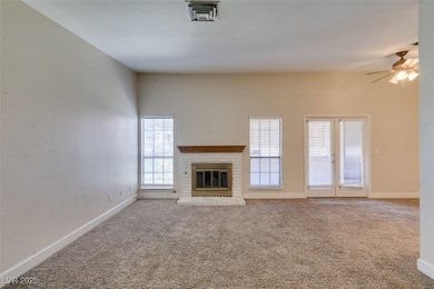 Unfurnished living room with ceiling fan, carpet,