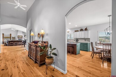a vaulted hallway invites you to a generously sized living room or the kitchen on the right.