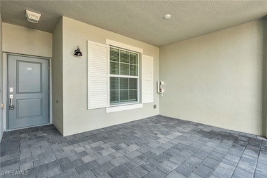 Property entrance featuring stucco siding