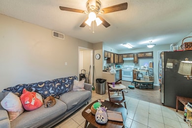 Unit 521 Living/Kitchen/Dining room featuring ceiling fan