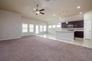 Kitchen featuring stainless steel microwave, open