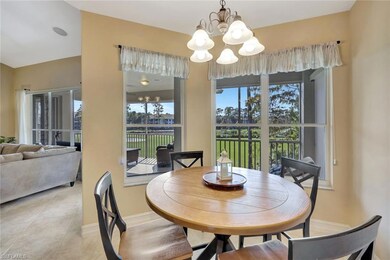Tiled dining area featuring a chandelier and baseboards
