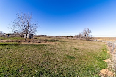 View of yard with a rural view and fence