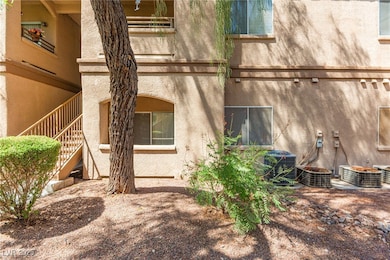 View of property exterior with stucco siding and stairs