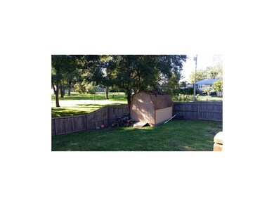 back lawn, wooded fence & storeage shed.