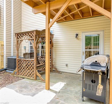 Stamped concrete patio in fenced backyard.