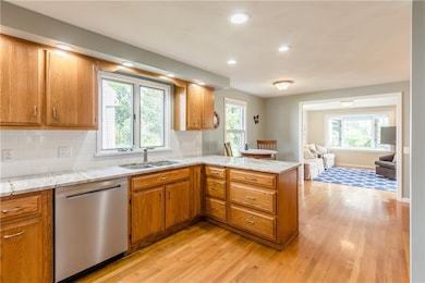 Eat-in kitchen with granite countertops open to fa