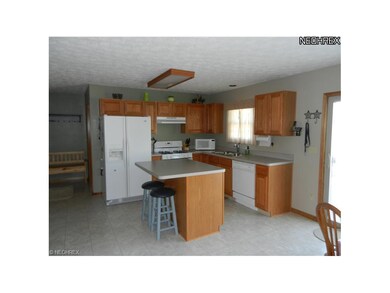 SPACIOUS KITCHEN FEATURES ISLAND COUNTER AND BREAK