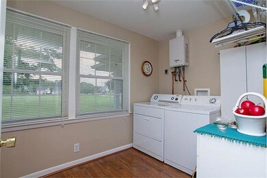 Large utility room is utilized as laundry room and has plenty of room for spacious pantry