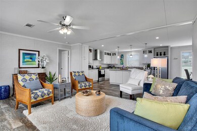 Living area featuring dark wood-style floors, cei