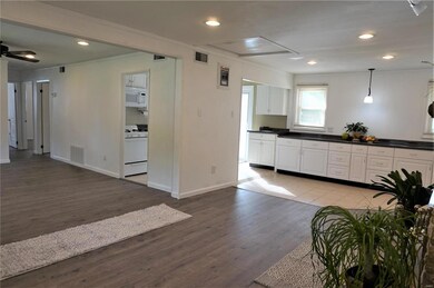 From the same corner of the family room note the tons of extra cabinets and counter space at the far end.