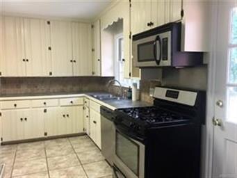 Cute kitchen with tile floor and back splash