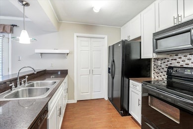 Kitchen featuring a sink, light wood-type floorin