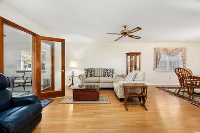 Living room with light wood-style floors, baseboar