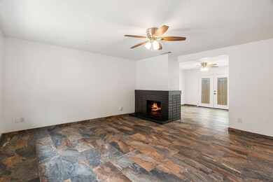 Unfurnished living room with a brick fireplace, a