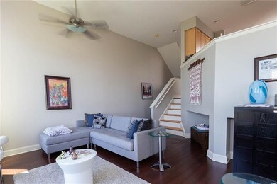Living room stairs up leading to kitchen/dining an