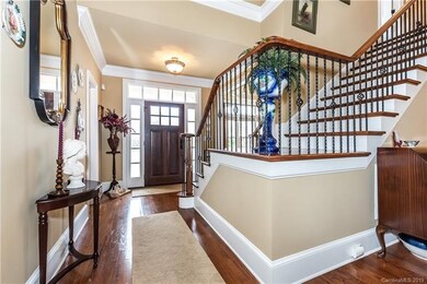 Grand foyer with beautiful hardwood floors
