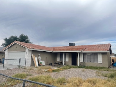 Ranch-style house with an attached garage, stucco