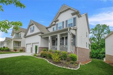 Craftsman house featuring covered porch, brick siding, a front lawn, driveway, and a garage