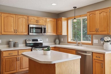 Prep Island with space for seating and sink situated below kitchen window