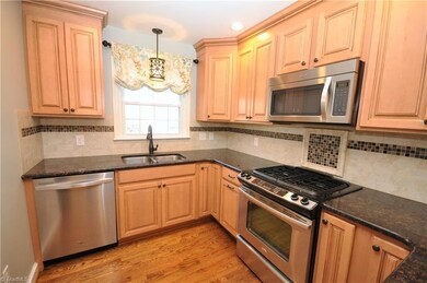 Granite tops and tile backsplash and maple cabs