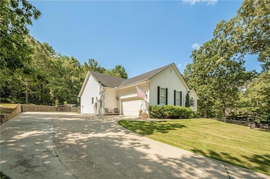 View of side of property with driveway and a garage