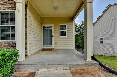 Doorway to property featuring a patio and stone siding