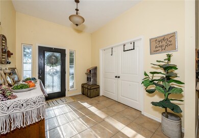 Entrance foyer featuring light tile patterned floors