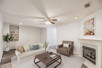 *Virtually staged* The large great room features a gas fireplace, recessed lighting, and a built-in bookcase.