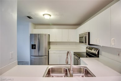 Airy pass-through into beautiful kitchen/stainless steel appliances