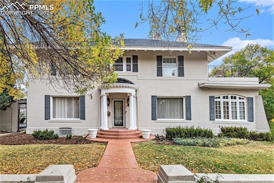 View of front facade with a front yard and a balco