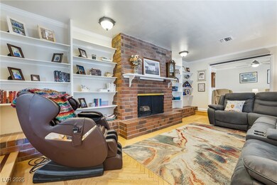 Living room with visible vents, a brick fireplace,