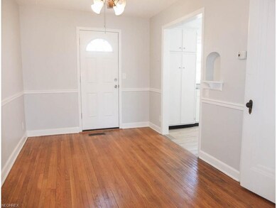 Formal dining room has wood flooring and a chair r