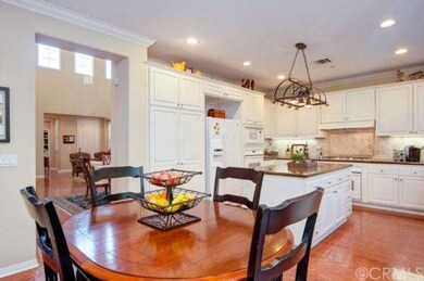 Gourmet kitchen with granite counters opens to a s