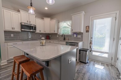 Kitchen featuring stainless steel microwave, a sin